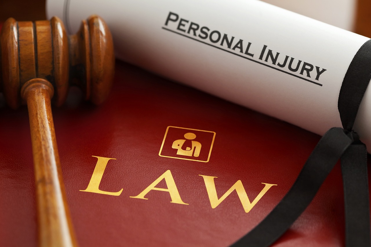 Gavel over Law book and document with the text "Personal Injury" on it